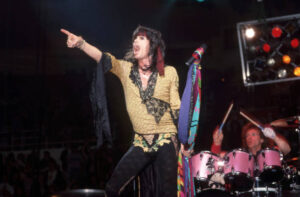Aerosmith lead singer Steven Tyler and drummer Joey Kramer perform during the band's Permanent Vacation Tour on December 5, 1987, at the Joe Louis Arena in Detroit, Michigan. 