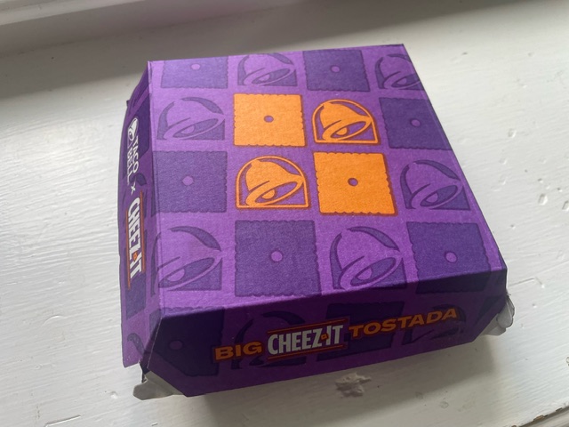 The Taco Bell Cheez-it tostada purple box on a white table 