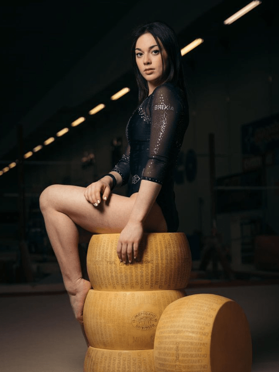 Giorgia Villa Posing on Wheels of Cheese